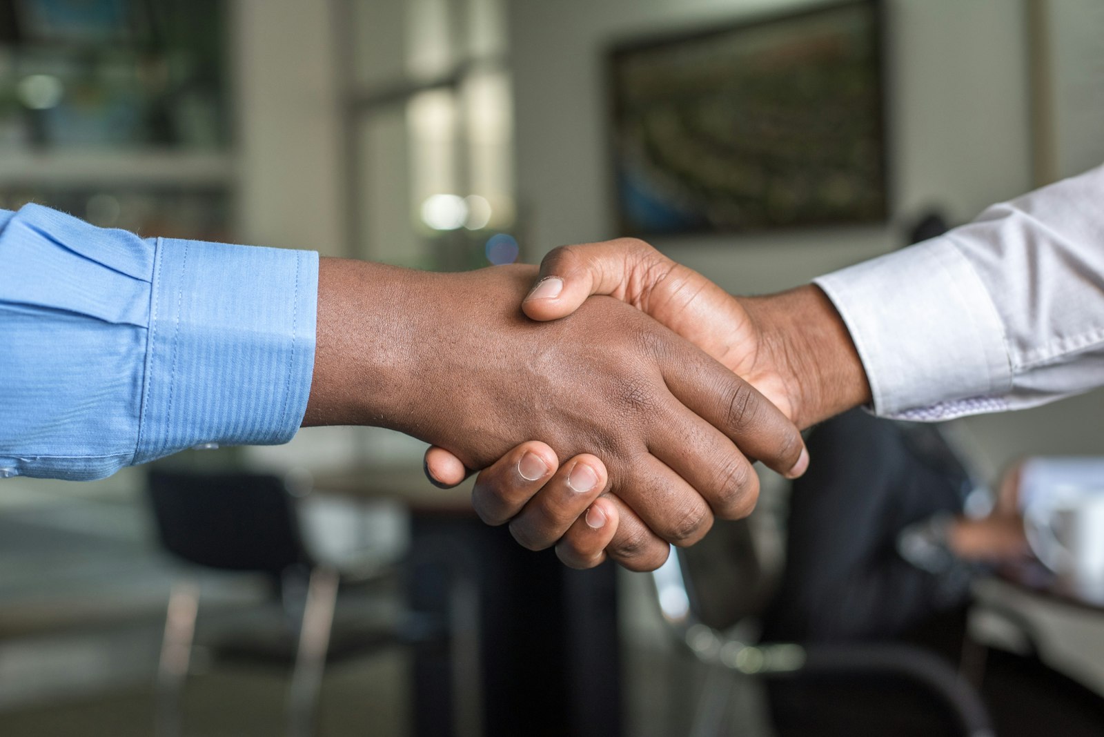 Two professionals shaking hands in an office — agreeing the scope and engagement model for a Salesforce integration project