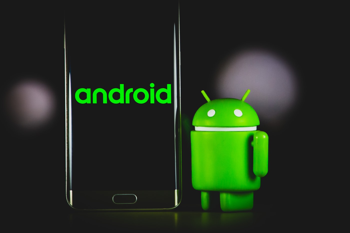 Android device next to the Android mascot