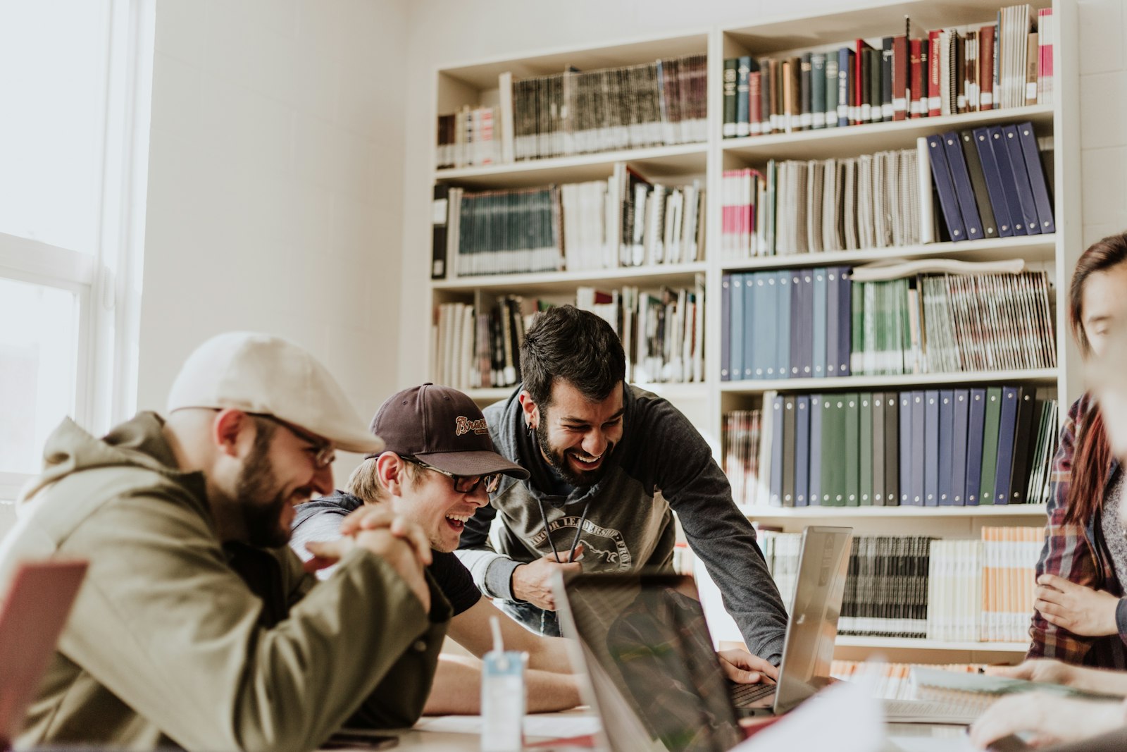 University students working together around laptops in a library — higher-education learners whose education records are protected by FERPA