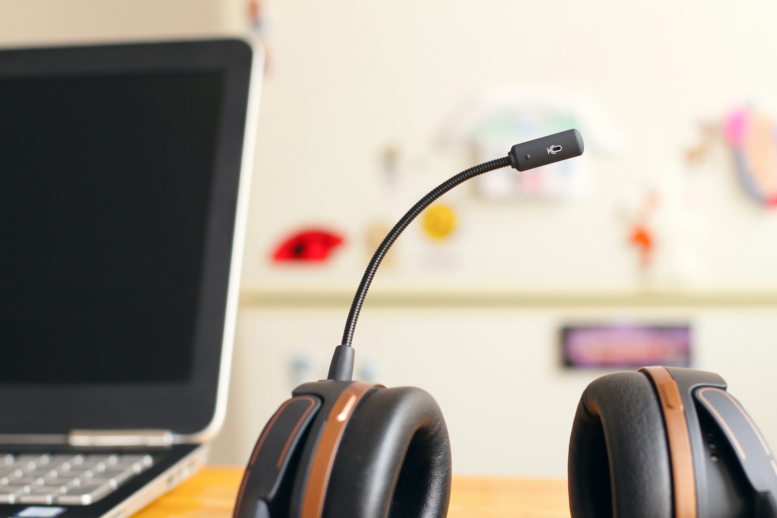 A headset and boom microphone beside a laptop on a support desk — the customer-support workload that AI chatbots are built to automate