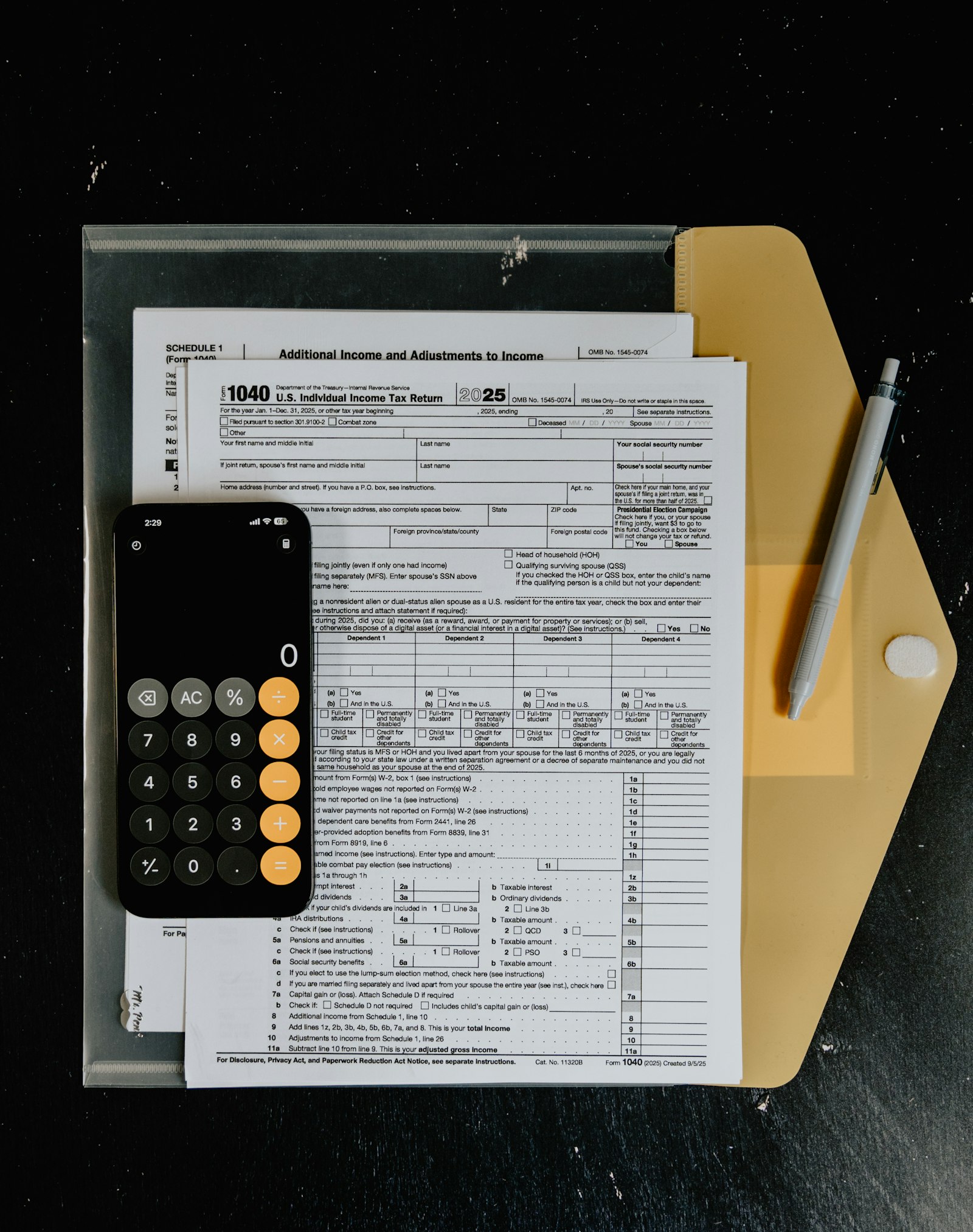 US tax forms, a calculator and a pen on a desk — tracking economic nexus and sales tax filing obligations for an online store