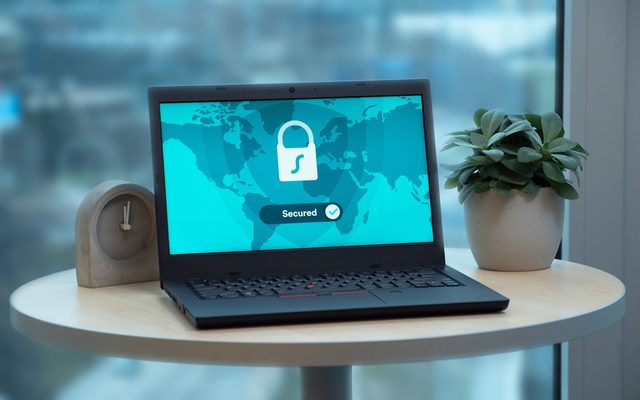 Laptop with security shield representing GDPR, ISO 27001 and SOC 2 compliance posture
